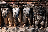 Thailand, Old Sukhothai - Wat Mahathat, stucco figures that decorate the base of the multi-layered chedi to the South of the complex. 